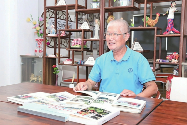 /徐峰向记者展示美篇部分图文作品打印编成的书籍